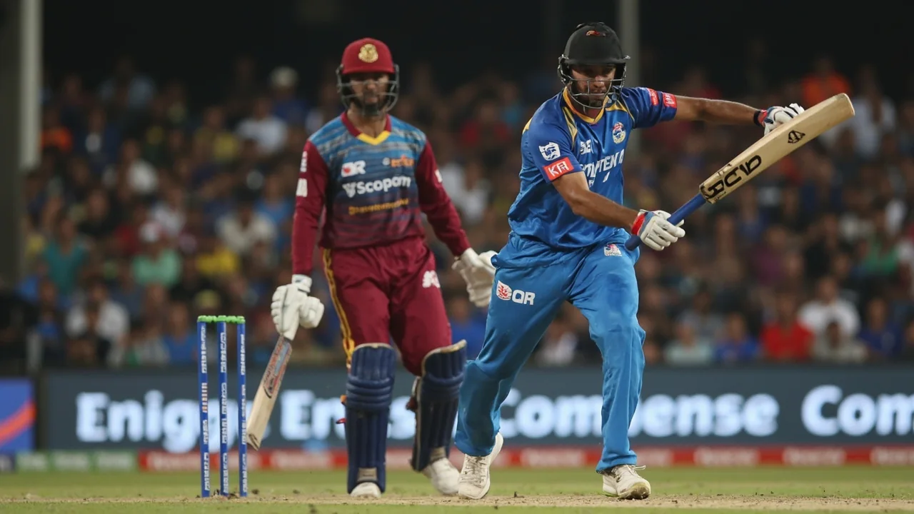 Sri Lankan all-rounder in mid-delivery stride at the Pallekele stadium under floodlights with the batter set at the non-striker end
